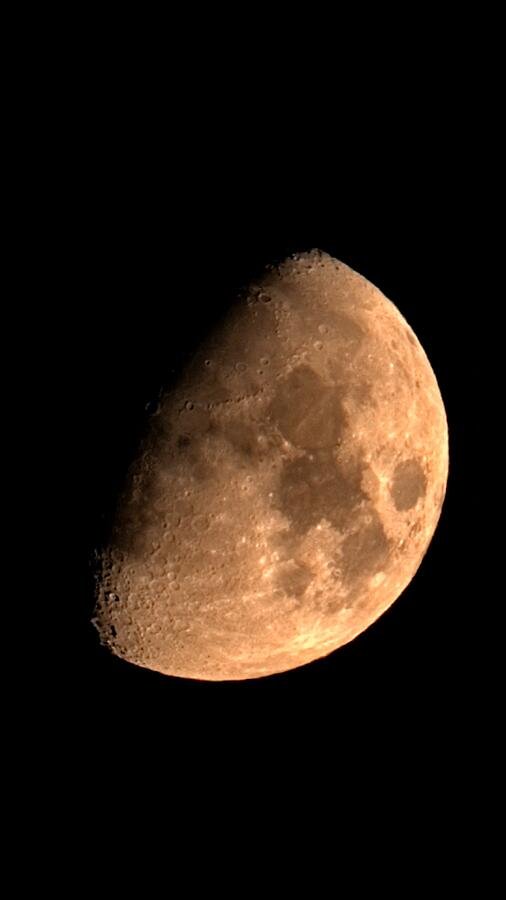 Waxing gibbous moon in the night sky (AI-generated art)